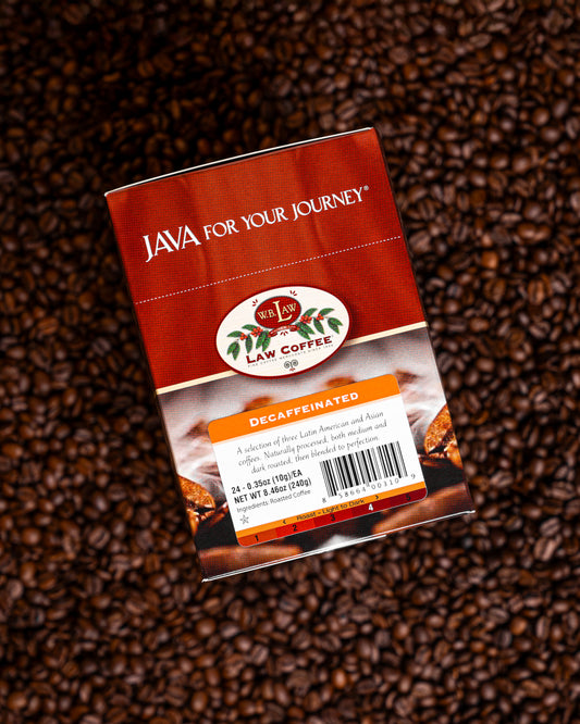 A pack of Decaf coffee single serve cups with the brand 'JAVA for your journey' placed on coffee beans background.
