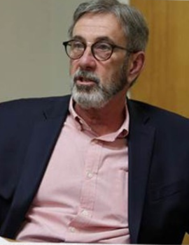 Chairman Emeritus David Mendez in a pink shirt and blue sport coat.