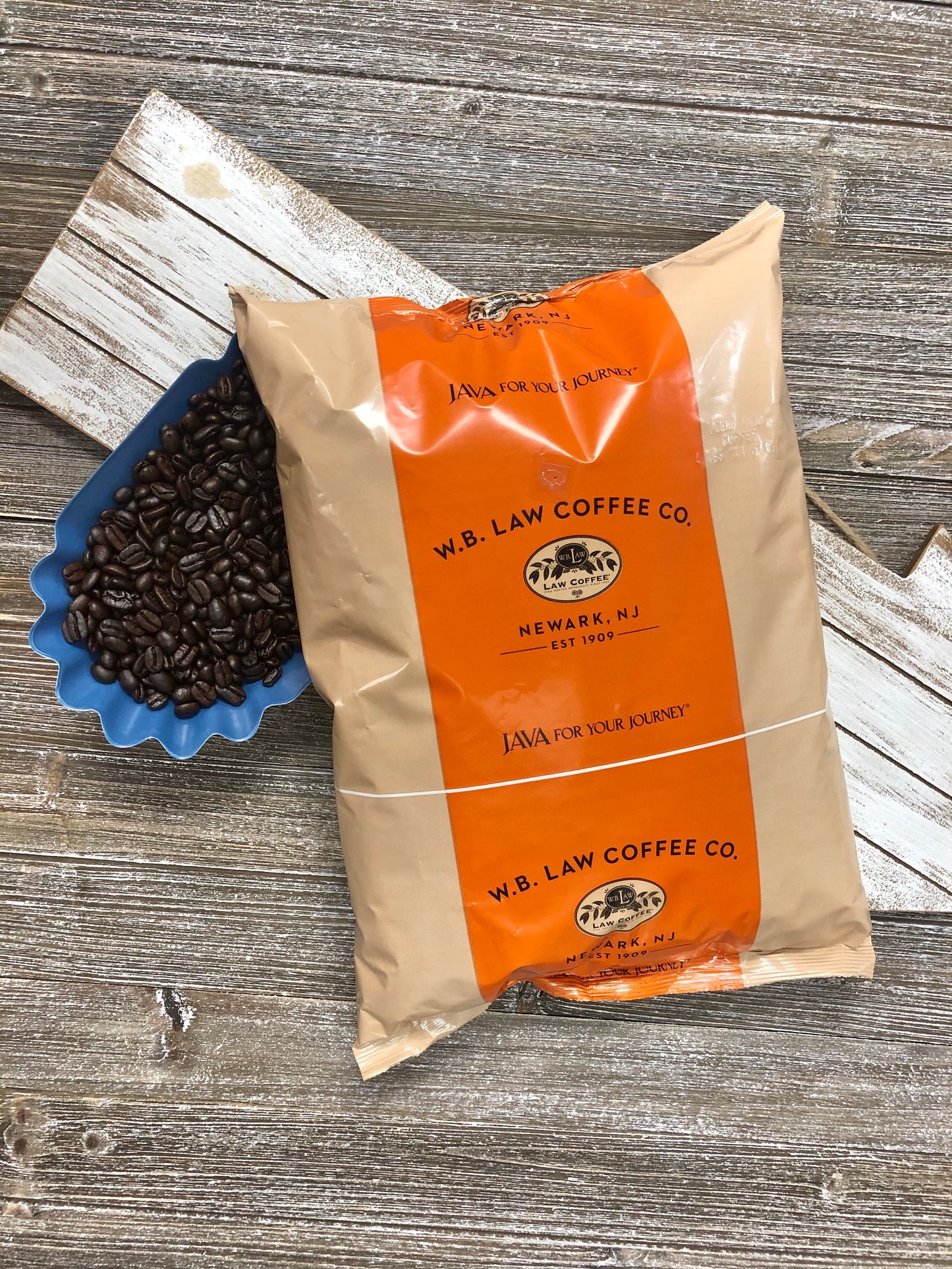 a bag of WB Law Coffee premium decaf coffee beans sitting on a wood table