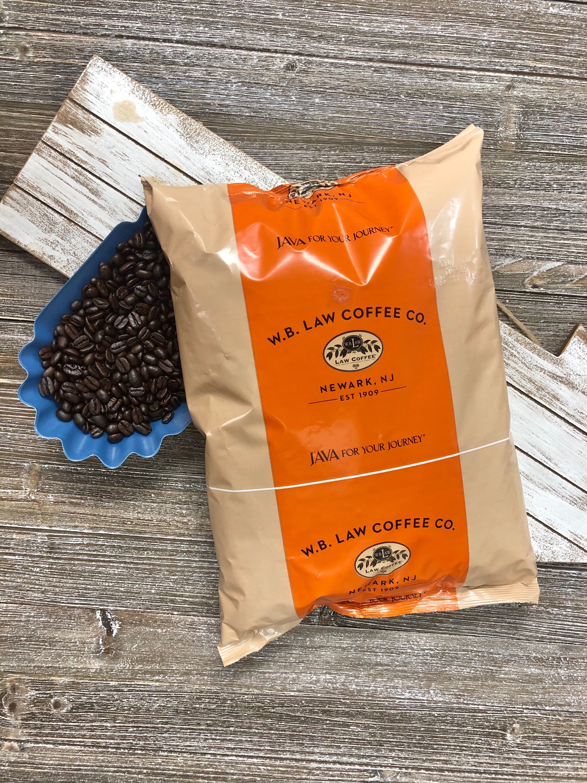 a bag of WB Law Coffee premium decaf coffee beans sitting on a wood table